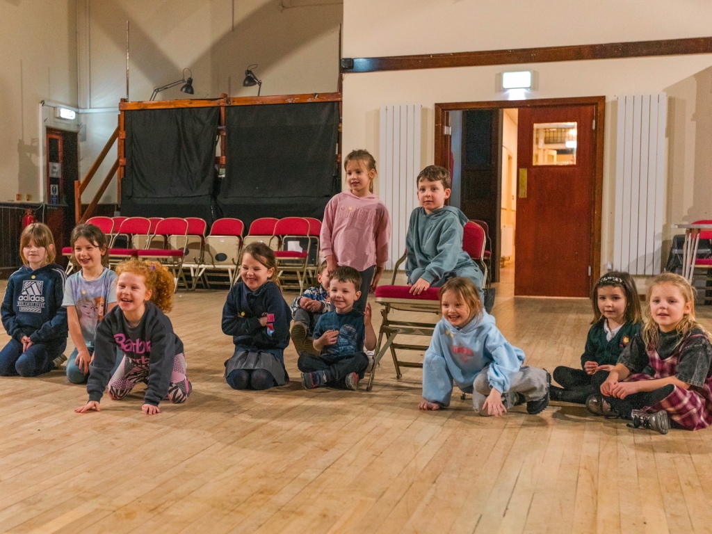 Kids learning stage presence in acting lessons