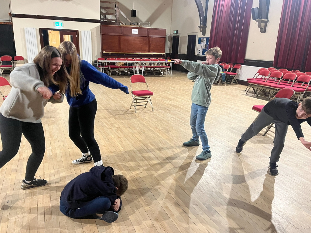 Acting instructor guiding children in a kids drama class in Clitheroe